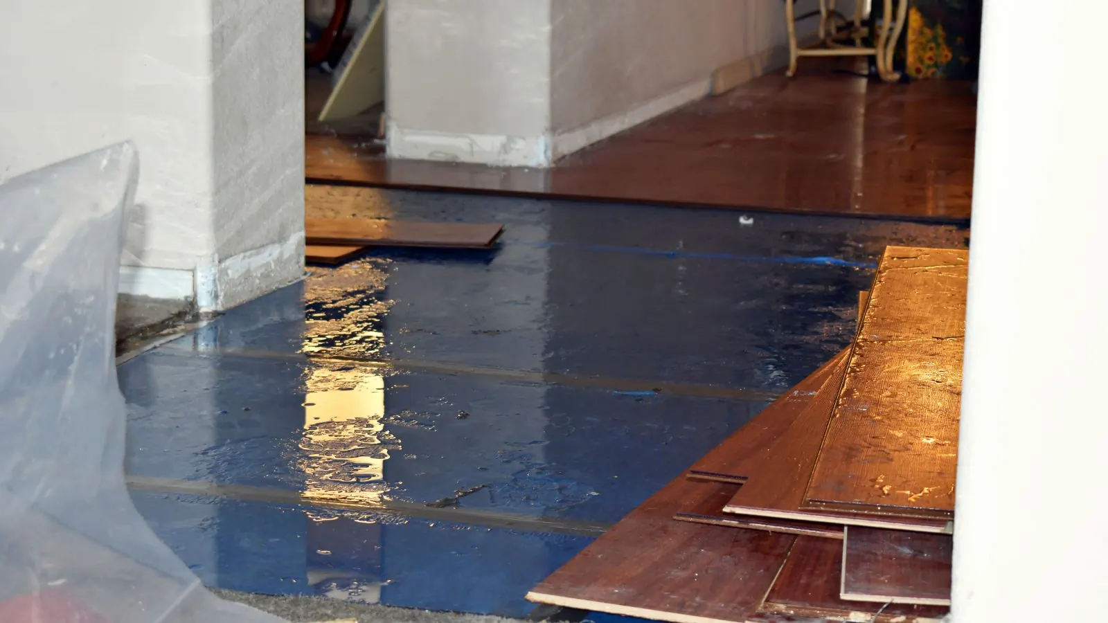 Wood floorboards lifted from the subfloor after water damage